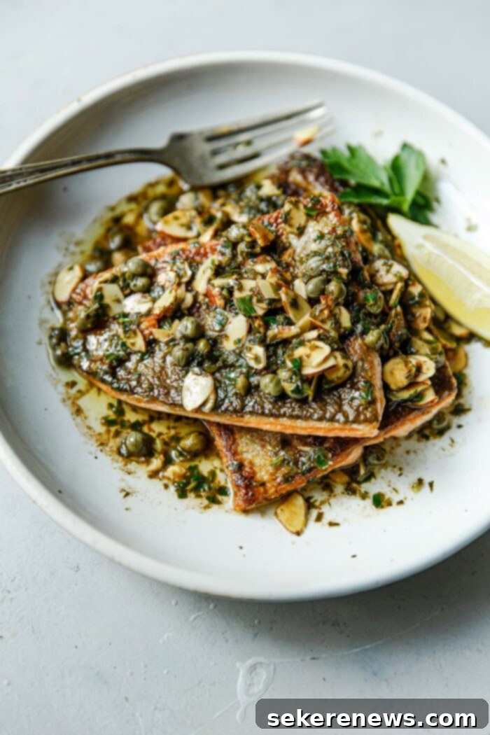 Brown Butter Almond Trout 2 Trout Almondine, elegantly plated with a rich brown butter sauce, toasted almonds, and fresh parsley.