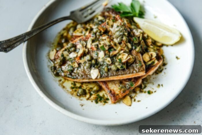 Brown Butter Almond Trout 11 Trout Almondine plated with the brown butter sauce spooned over the crispy fish.