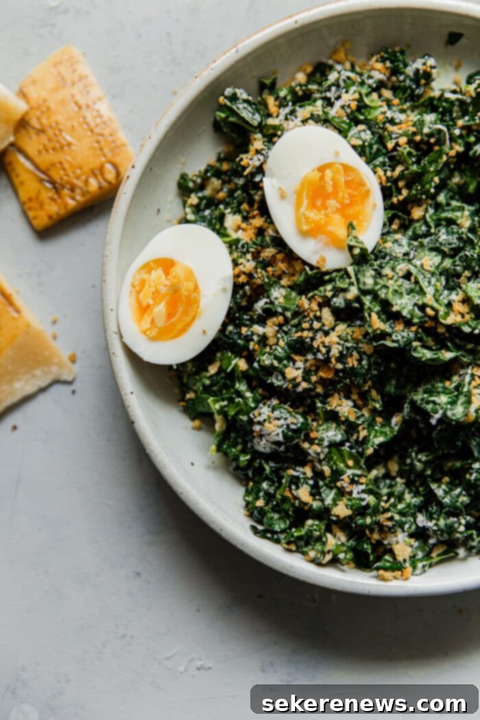 Signature Kale Caesar 13 Kale Caesar Salad garnished with sliced hard-boiled eggs, crispy breadcrumbs, and parmesan.