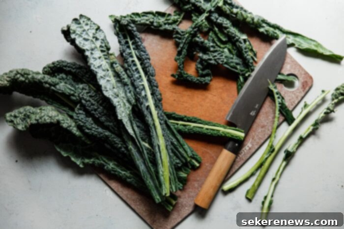 Signature Kale Caesar 4 Hands stripping tough stems from lacinato kale leaves, preparing them for a delicious Caesar salad.