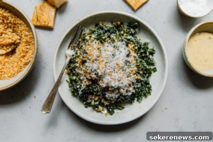 Signature Kale Caesar 7 A bowl of fresh kale mixed with Caesar dressing, ready for serving.