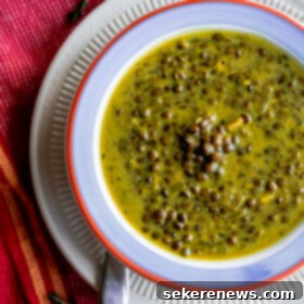 Coconut-Infused Indian Spiced Green Lentil Soup 2 Green Lentil Soup with Coconut Milk & Indian Spices served in a bowl.
