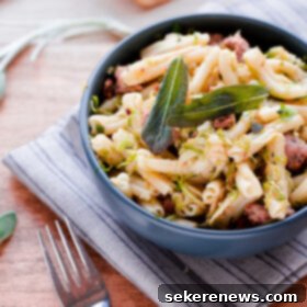 Rustic Strozzapreti with Crumbled Pork Sausage, Shaved Brussels, and Fragrant Sage 7 Strozzapreti with Pork Sausage, Shaved Brussel Sprouts, and Sage - A plated dish ready to serve.