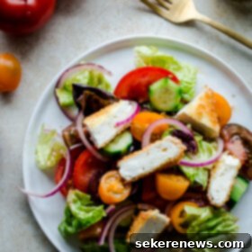 Golden Feta Greek Salad 8 A beautifully plated Greek Salad featuring a generous topping of golden brown, perfectly crispy feta cheese.