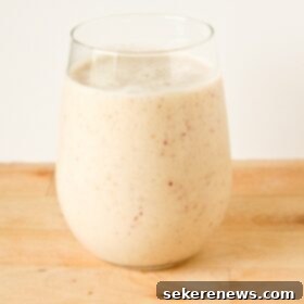 Peachy Banana Bliss 5 Close-up of a Banana Peach Vanilla-Maple Almond Milk Smoothie in a glass