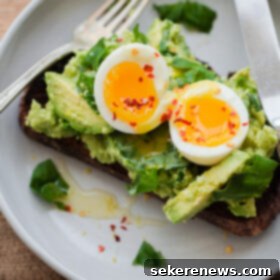 Gourmet Avocado Toast 2 Fancy Avocado Toast - chunky avocado with lemon, chili flakes, basil - topped with a soft boiled egg!