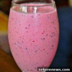 Sun-Kissed Berry Peach Delight 4 Summertime Berry Peach Smoothie, a glass filled with a refreshing blend of fruits and Kefir.