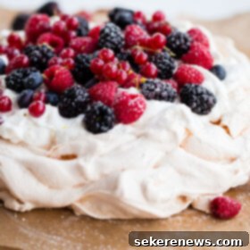 Luscious Berry Pavlova with Zesty Lemon Cream 2 Delicious and Easy Lemon Berry Pavlova Recipe - this delicious pavlova is filled with lemon whipped cream and fresh berries!