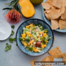Mango Tango Guacamole 2 Tropical Mango Guacamole. Traditional guacamole is given a tropical twist with juicy mango and jicama! Perfect appetizer for Cinco de Mayo.