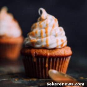 Spiced Pumpkin Cloud Cupcakes 7 Pumpkin Cupcakes with Marshmallow Frosting and Caramel. This decadent fall cupcakes are lightly spiced and make a wonderful portable fall dessert.