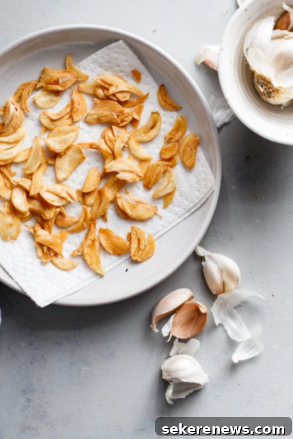 How to Make Crispy Garlic Chips - An easy, no-fuss tutorial on how to make crispy garlic chips at home, and ways to incorporate them into your cooking repertoire. Crispy Garlic Chips on Plate