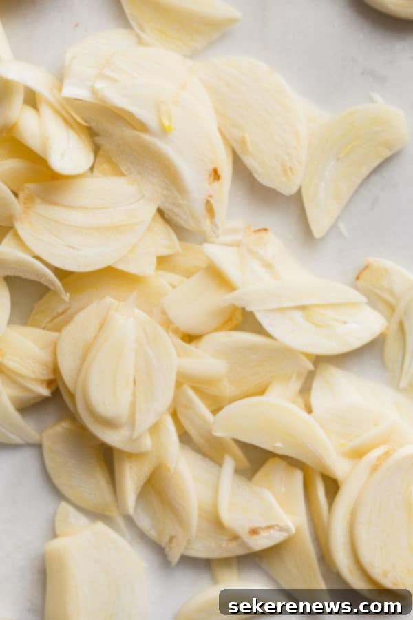 How to Make Crispy Garlic Chips - An easy, no-fuss tutorial on how to make crispy garlic chips at home, and ways to incorporate them into your cooking repertoire. Thinly Sliced Raw Garlic