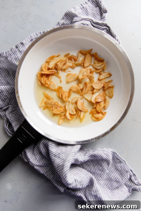 How to Make Crispy Garlic Chips - An easy, no-fuss tutorial on how to make crispy garlic chips at home, and ways to incorporate them into your cooking repertoire. Garlic Chips in Skillet