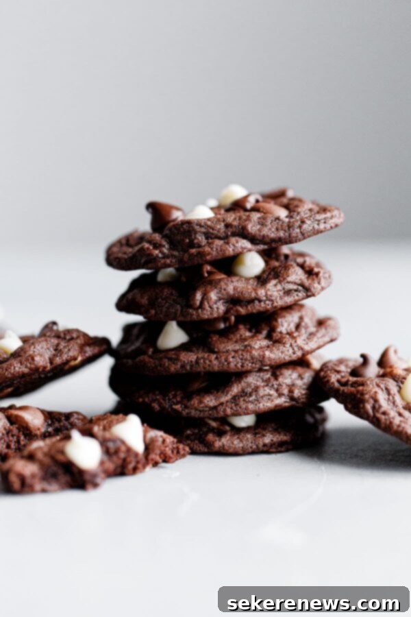Chewy Triple Chocolate Cookies - A perfect recipe for soft and chewy cookies with white, milk, and semisweet chocolate chips. Great for dessert and holidays. Stacked Chewy Triple Chocolate Cookies with a Mix of White, Milk, and Semisweet Chocolate Chips