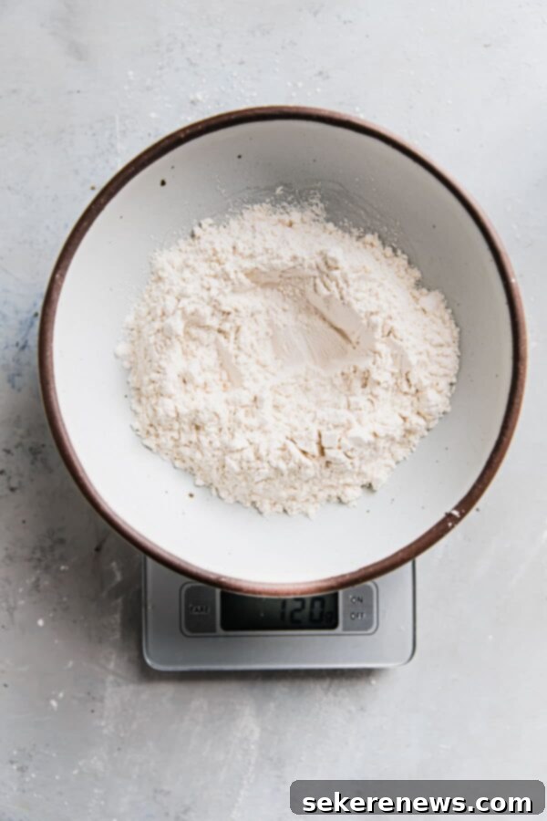 Mastering Flour Measurement 7 Close-up of a digital baking scale displaying the exact weight of flour in grams, demonstrating accurate measurement.