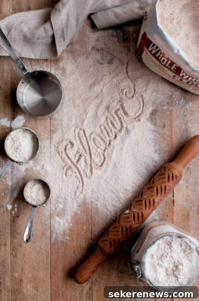 Sourdough Starter Troubleshooting: Your Essential Guide and FAQ 2 Flour Dusted on Wood Board with Measuring Cups