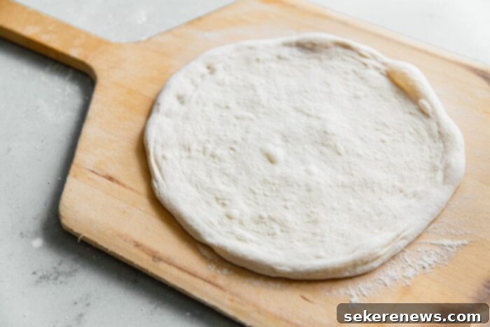 Perfect Sourdough Pizza Dough 24 Stretched Sourdough Pizza Dough on Wooden Pizza Peel