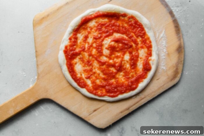Perfect Sourdough Pizza Dough 25 Pizza Sauce Spread on Pizza Dough