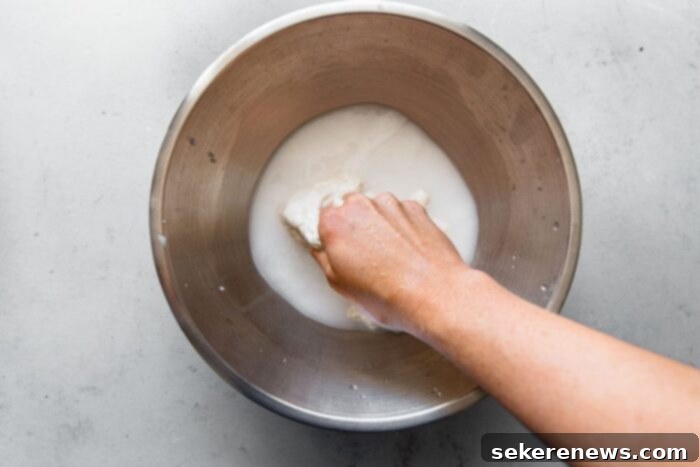Perfect Sourdough Pizza Dough 5 Mixing Sourdough Starter into Water for Pizza Dough