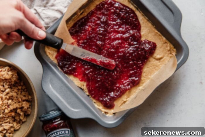 Toasted Hazelnut Raspberry Crumble 5 Spreading St.Dalfour Raspberry Fruit Spread on Batter