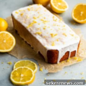 Zesty Lemon Pound Cake 9 The ultimate moist and tart Lemon Loaf Cake with a zesty lemon glaze, garnished with fresh lemon zest, showcasing its delightful golden hue.