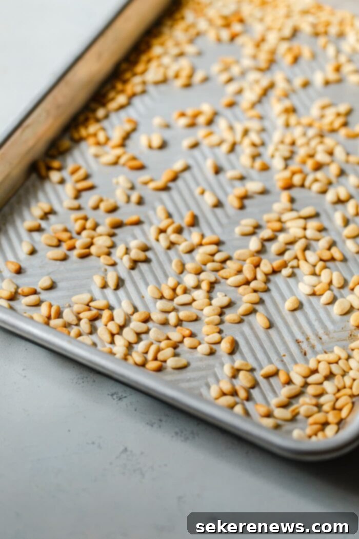 Toast Pine Nuts Like a Pro 3 Toasting Pine Nuts in Oven on a sheet pan for even browning