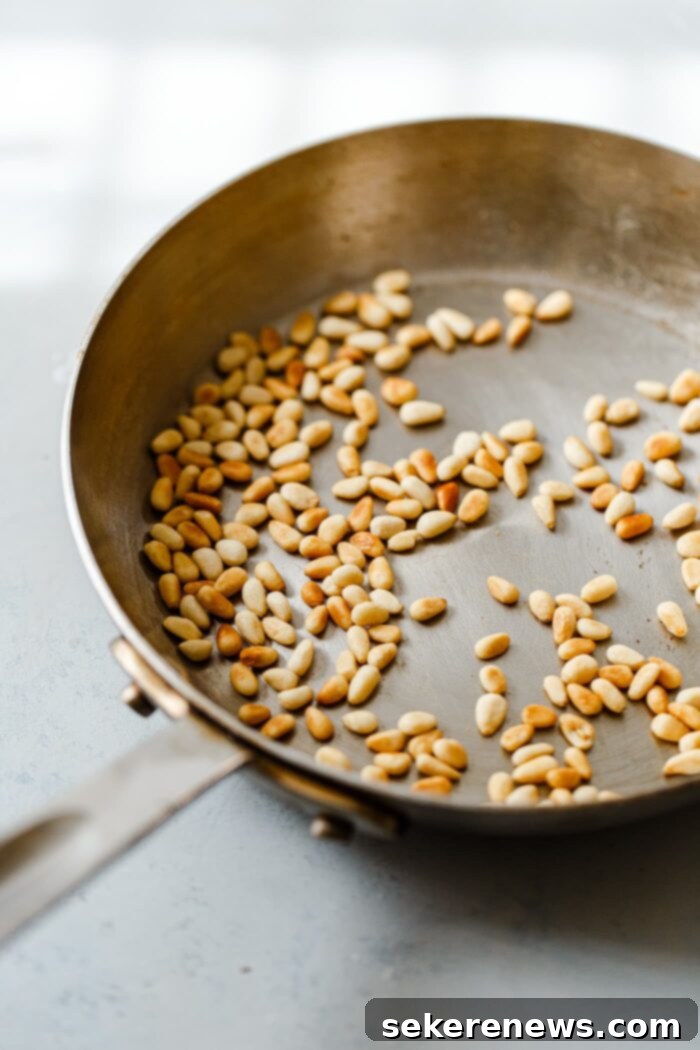 Toast Pine Nuts Like a Pro 8 Perfectly dry toasted pine nuts in a skillet, golden and fragrant