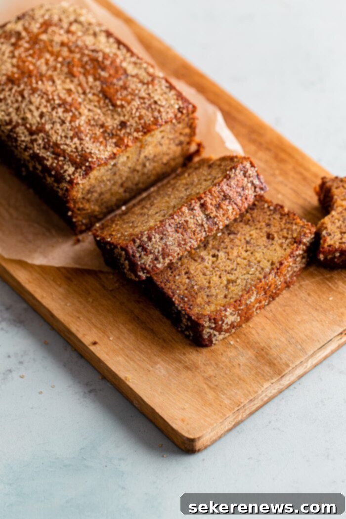 Ultimate Moist Banana Bread 3 Whole Moist Banana Bread Loaf on a Wooden Cutting Board
