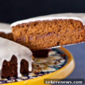 Gingerbread Teatime Cake 7 Beautifully presented Gingerbread Tea Cake with Raspberry Jam and Lemon Glaze, ready for serving. A visual representation of the final dessert.
