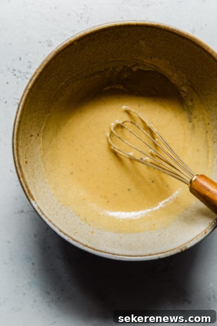 Hearty Autumn Farro Salad 10 A close-up of the smooth, creamy maple tahini dressing in a bowl, ready to be used.