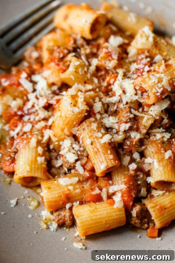 Marcella Hazan's Classic Bolognese 2 Rich, classic Marcella Hazan Bolognese sauce simmering in a Dutch oven with pasta