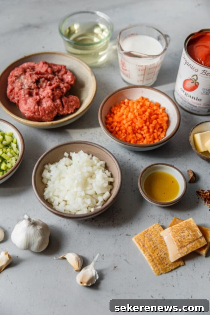 Marcella Hazan's Classic Bolognese 4 Key ingredients laid out for Marcella Hazan Bolognese: olive oil, butter, vegetables, ground beef, milk, wine, tomatoes, and Parmesan rinds