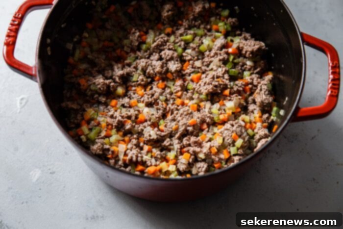 Marcella Hazan's Classic Bolognese 7 Step-by-step: Bolognese simmering with milk and wine after adding meat