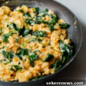 Fluffy Cheesy Scramble with Fresh Greens 10 Cheesy Scrambled Eggs with Greens in Skillet
