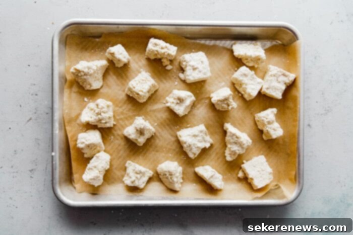 Spicy Chili Peanut Tofu Crunch 9 Cornstarch Tofu on Parchment Lined Baked Sheet, ready for oven
