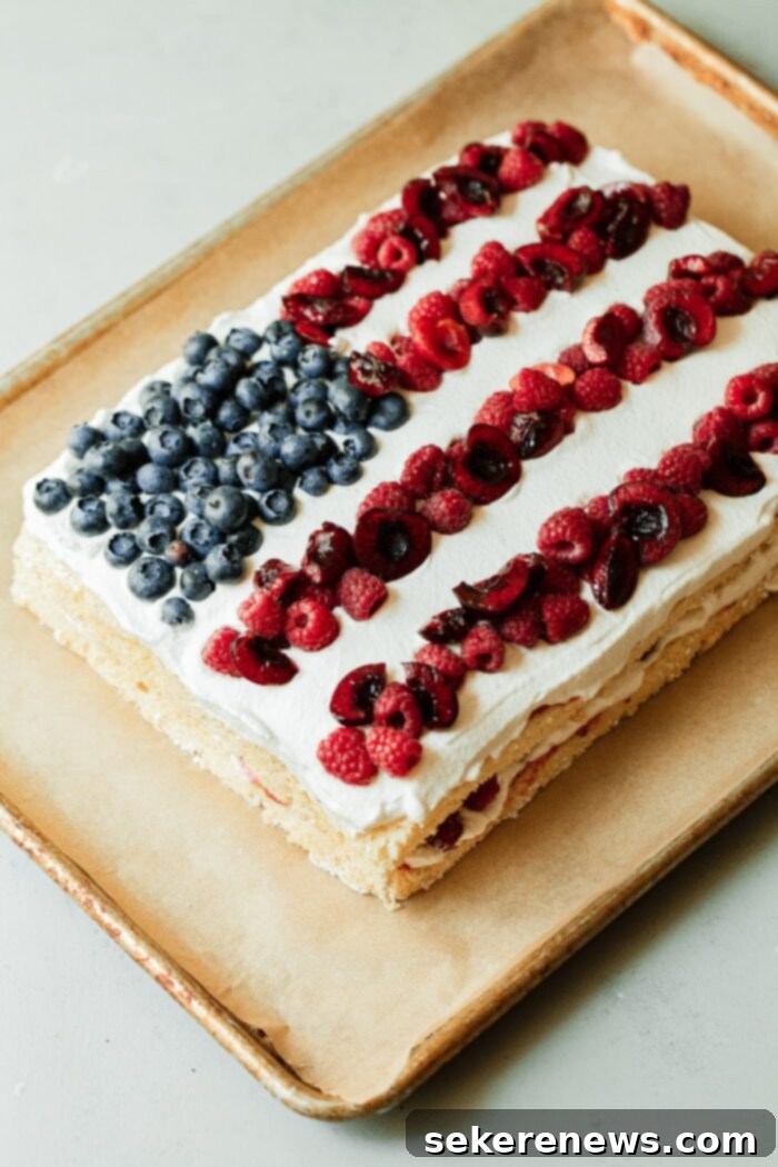 Patriotic Pride Cake 2 Stunning American Flag Cake decorated with fresh berries and whipped cream.