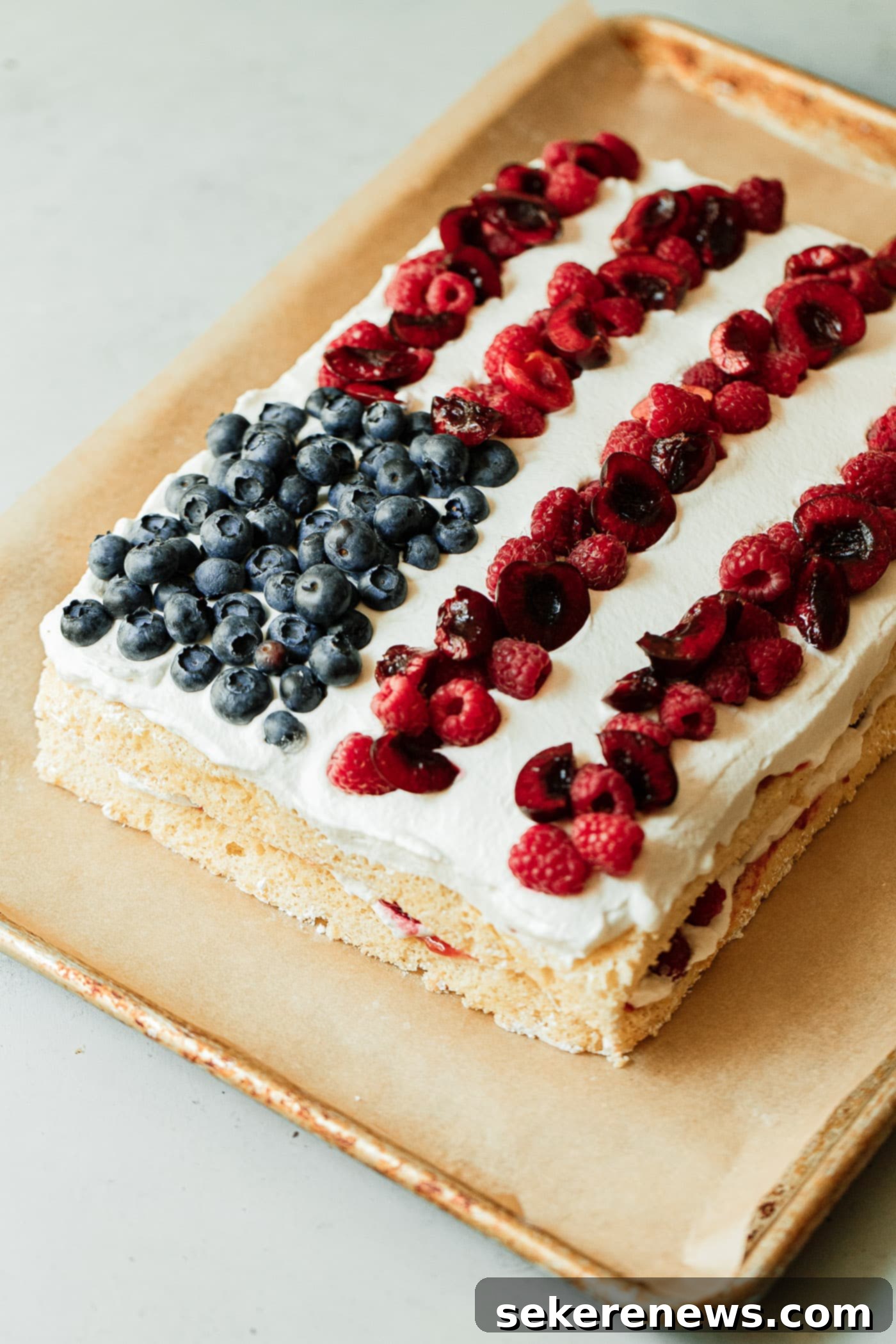 Patriotic Pride Cake 14 Sliced American Flag Cake showing layers of sponge, cream, and berries.