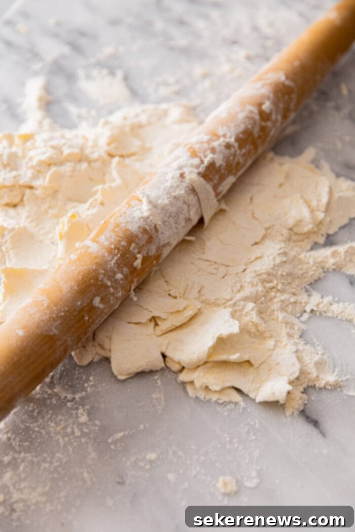 The Ultimate Flaky Quiche Pastry 5 Rolling Cold Butter into Flour for Homemade Quiche Crust